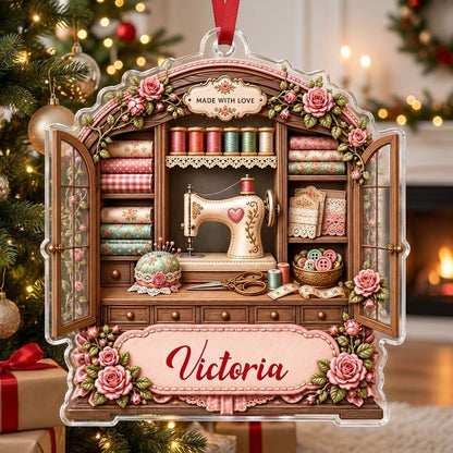 Acrylic ornament shaped like a sewing cabinet with roses, sewing machine, scissors and a pink name banner.