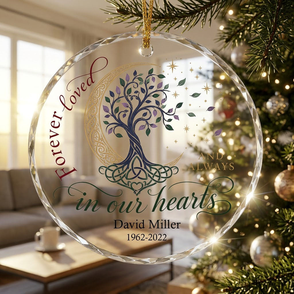 Round glass ornament with Celtic tree of life, gold crescent moon, stars, and phrase Forever loved in our hearts.