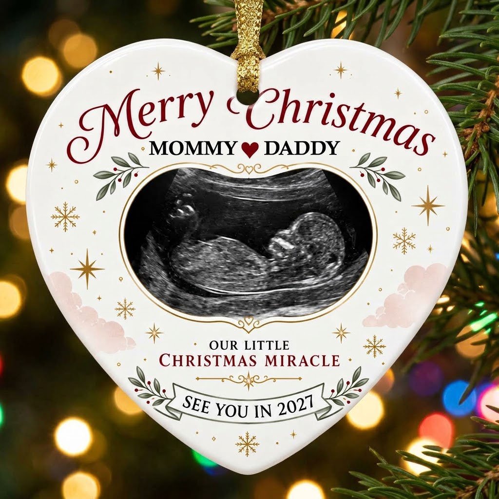 Heart ceramic ornament with ultrasound photo, gold starbursts, green leaves with red berries, and a bottom banner.
