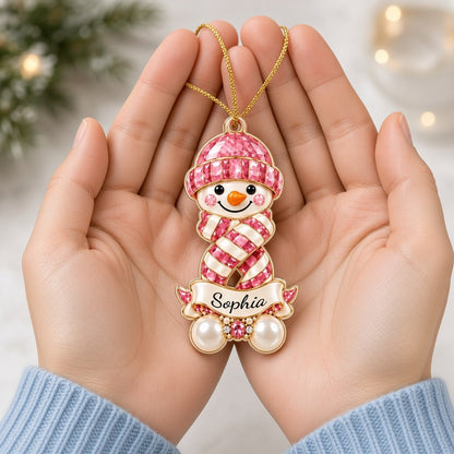 Custom-cut acrylic snowman ornament with jeweled hat and scarf, name banner, and faux pearl base.