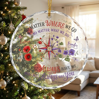 Round glass ornament with a compass rose, red and purple flowers, butterflies, dragonflies, and long-distance quotes.