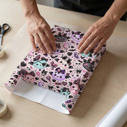 Pastel goth Halloween wrapping paper with cute bat-winged characters, skulls, moons, bows and candies.