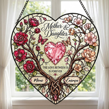 Heart-shaped stained-glass style suncatcher with intertwined trees, red and pink flowers, butterflies, and a pink gem he