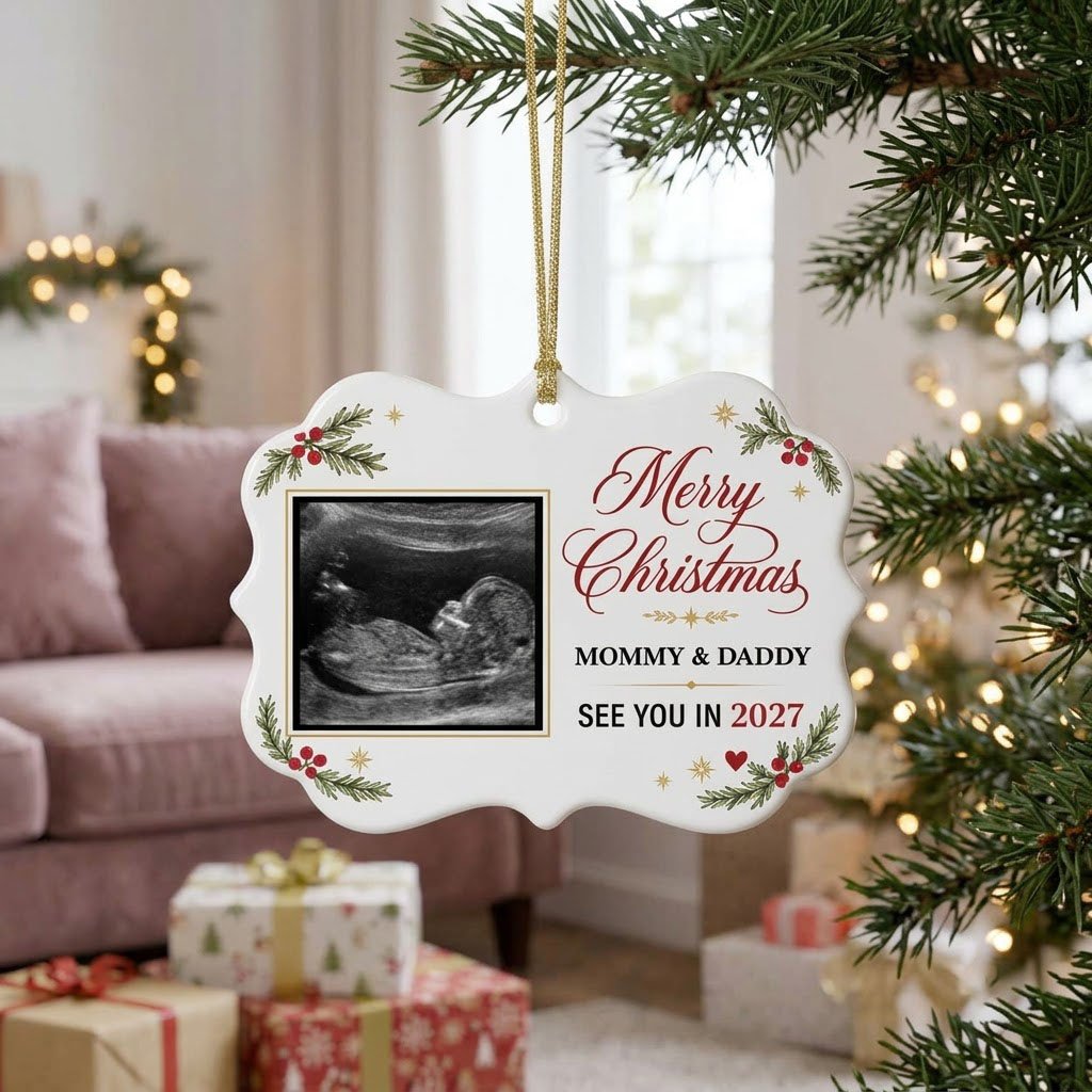 Round ceramic ornament with ultrasound photo, pine branches with red berries, gold starbursts and a red heart icon.