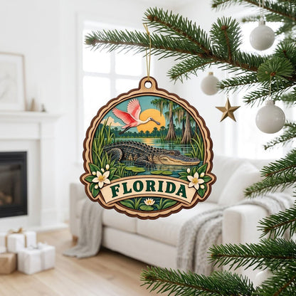 Scalloped wood ornament with alligator, pink spoonbill, sun, cypress trees, and 'FLORIDA' on a bottom banner.