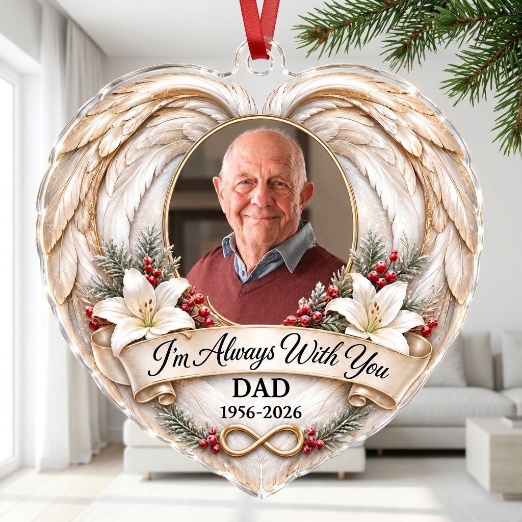 Heart-shaped acrylic ornament with angel wings, oval photo frame, white lilies, pine sprigs, red berries, and 'I'm Alway