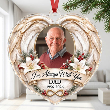 Heart-shaped acrylic ornament with angel wings, oval photo frame, white lilies, pine sprigs, red berries, and 'I'm Alway