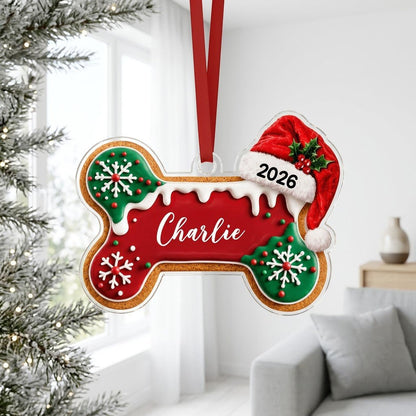 Acrylic ornament shaped like a gingerbread dog bone with Santa hat, white icing, snowflakes, and red-green sprinkles.