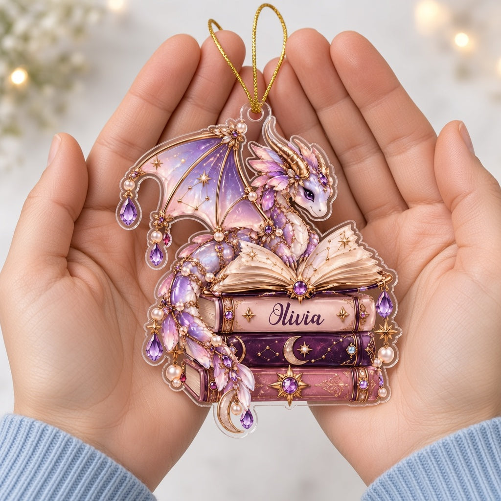 Pastel purple and gold dragon on an open book atop stacked books with jewels and pearls on a clear acrylic ornament.