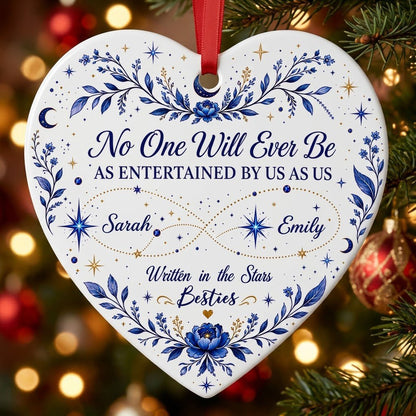 White heart ceramic ornament with blue florals, moons, stars, and “Written in the Stars Besties” with two names.