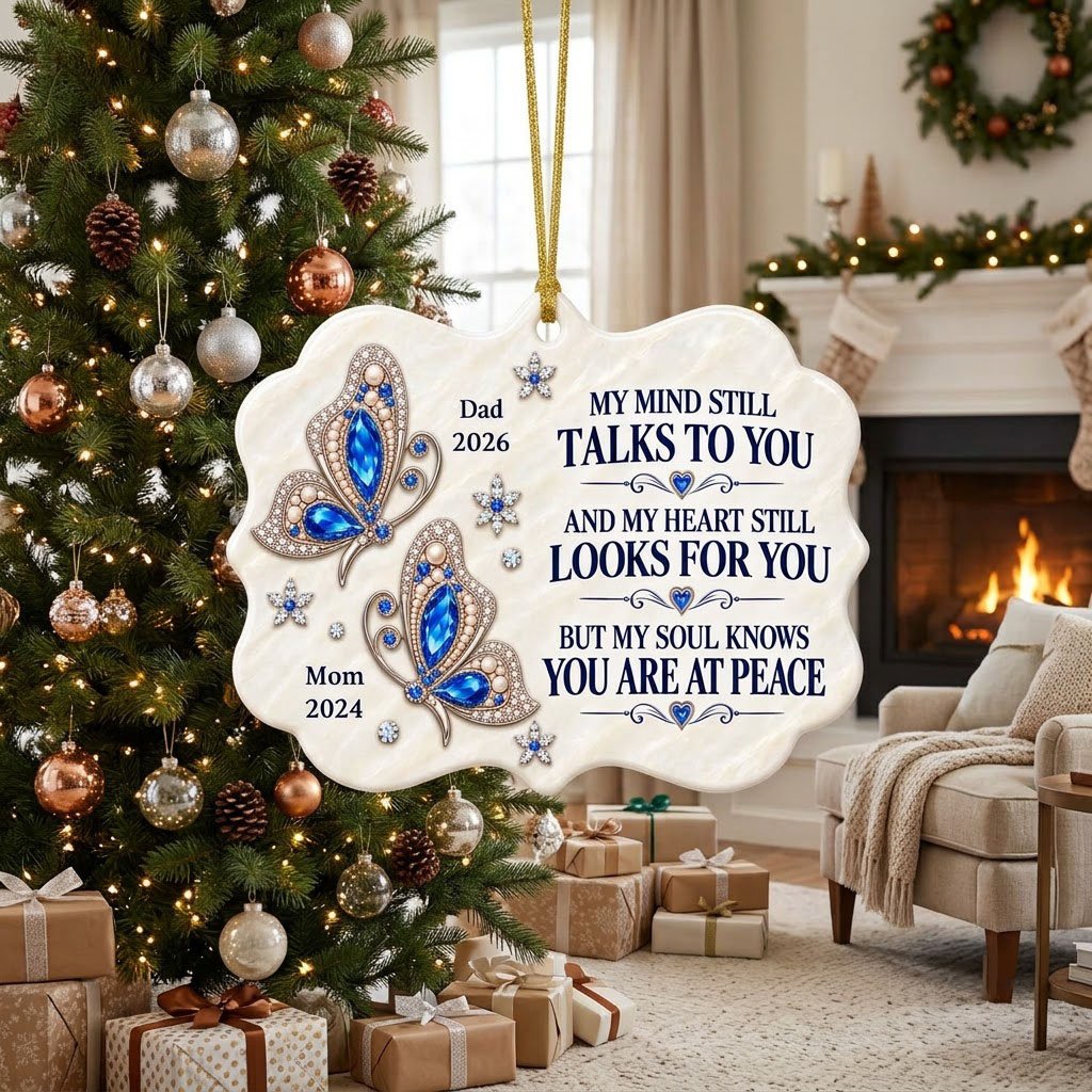 Scalloped ceramic ornament with two blue jeweled butterflies, silver starburst flowers and a memorial quote.