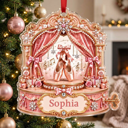 Pink ballet music box ornament with pointe shoes, velvet curtains, pearls, snowflakes, and a name plaque.