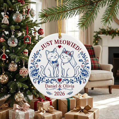 Round ceramic ornament with two wedding cats, 'JUST MEOWIED!', names and year with blue and red folk floral accents