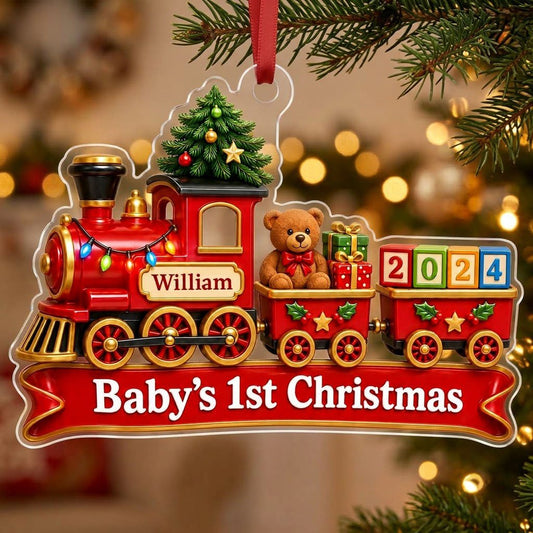 Acrylic ornament shaped like a red toy train with tree, teddy bear, number blocks, and Baby's 1st Christmas text.
