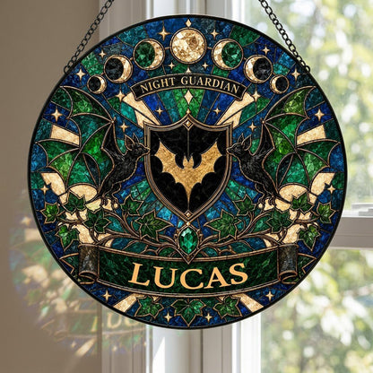 Round stained-glass suncatcher with gold bat shield, two black bats, moon phases, emerald gem, ivy and starbursts.