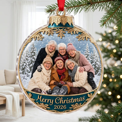 Clear acrylic bauble ornament with photo of six women in snowy pines, gold filigree, teal banner and Merry Christmas tex