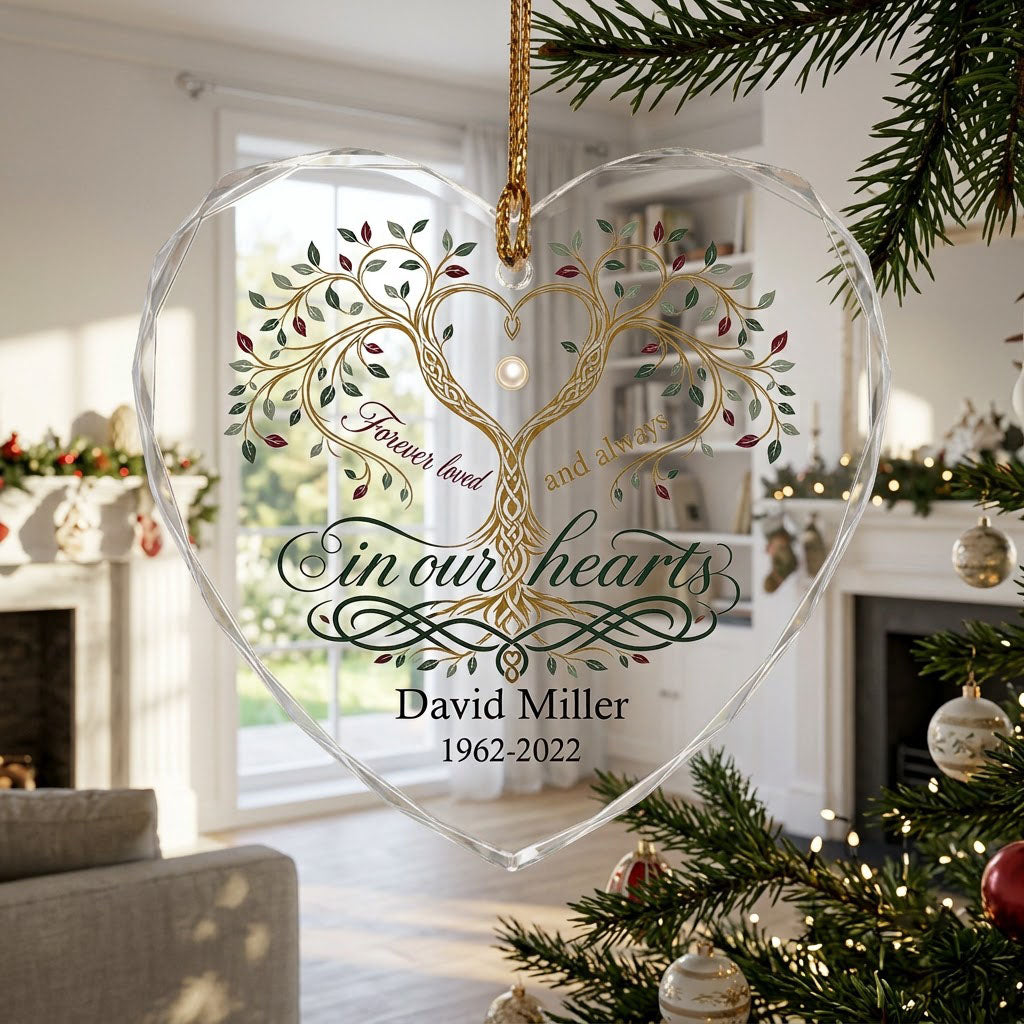 Heart glass ornament with a golden tree of life and the text 'Forever loved and always in our hearts'.