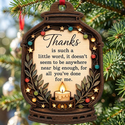 Lantern-shaped wood ornament with candle, colorful fairy lights, leafy branches, and a thank-you quote.