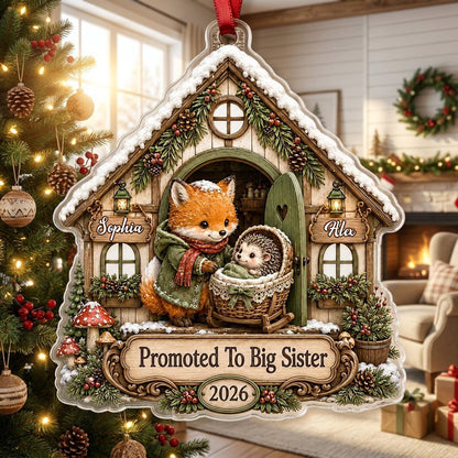 House-shaped acrylic ornament with 'Promoted To Big Sister' and a fox beside a baby hedgehog in a bassinet.
