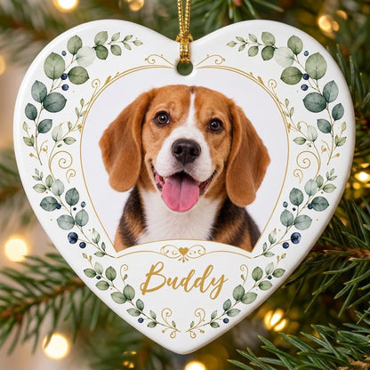 Heart ceramic ornament with a pet photo framed by gold heart scrollwork and eucalyptus with dark blue berries.