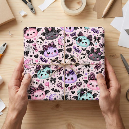 Pastel goth Halloween wrapping paper with cute bat-winged characters, skulls, moons, bows and candies.