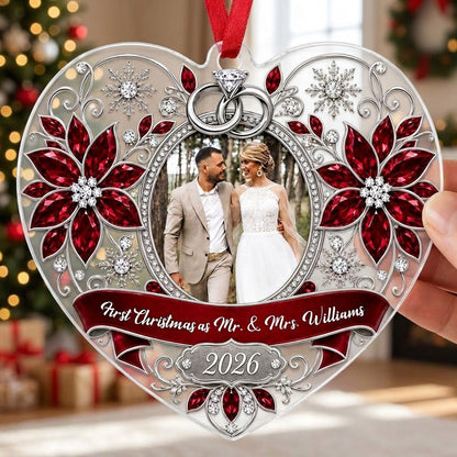 Heart acrylic ornament with couple photo, silver rings, poinsettias, and First Christmas as Mr. & Mrs. 2026.