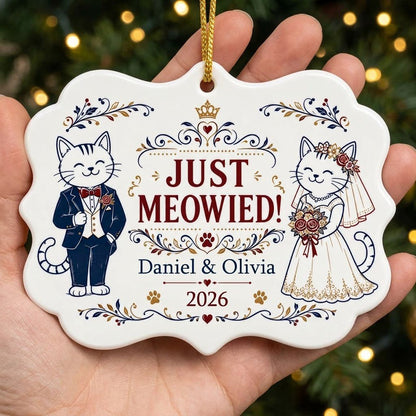 Medallion ceramic ornament with cat bride and groom, gold crown, floral scrolls, red hearts and paw prints on white.
