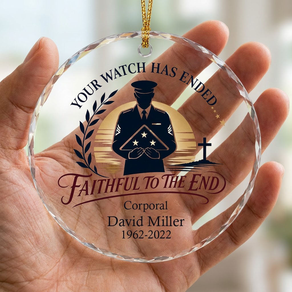 Round glass ornament with officer silhouette holding a folded flag, golden sunset, cross, and the words YOUR WATCH HAS E