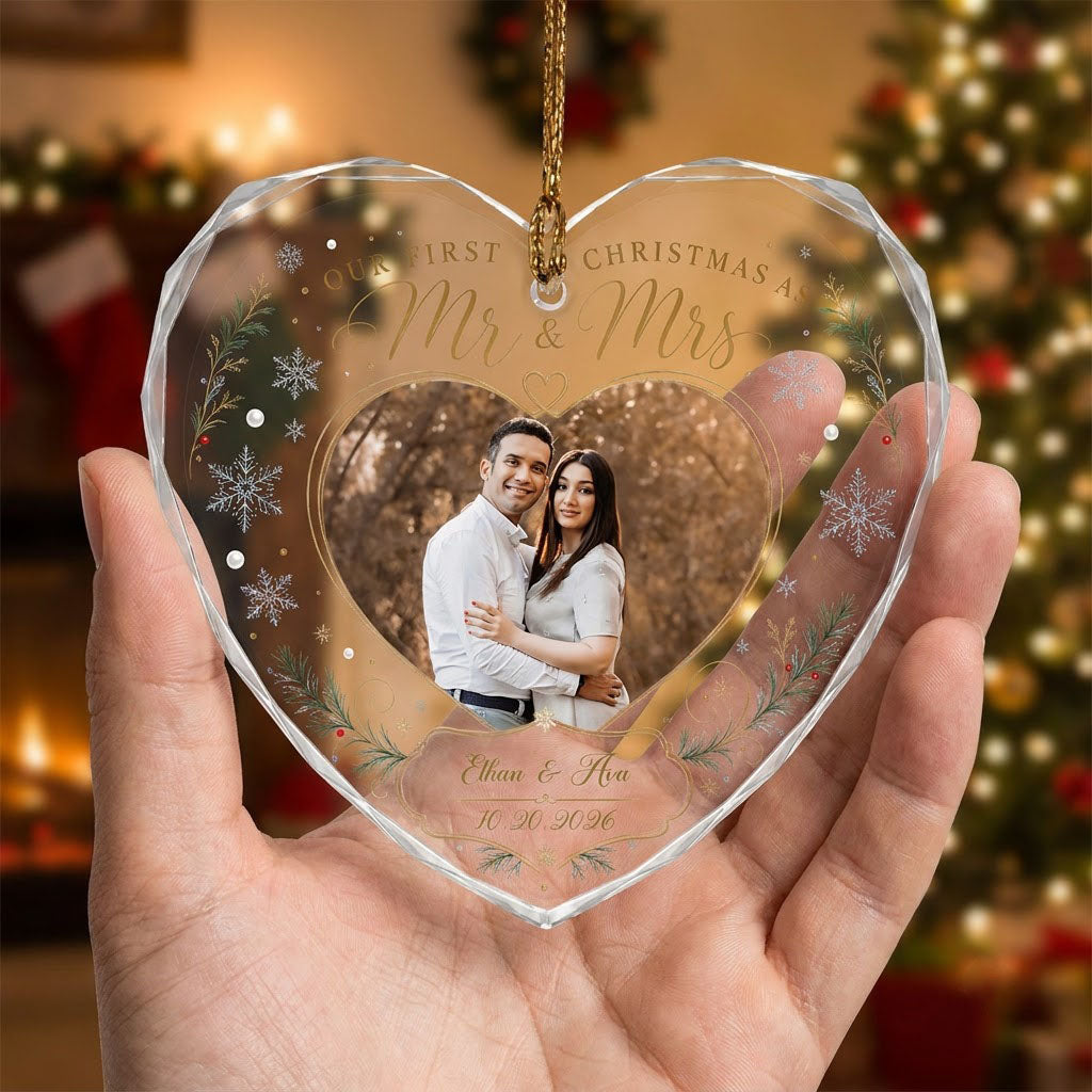 Heart-shaped glass ornament with couple photo, 'Our First Christmas As Mr & Mrs', pine sprigs, berries and gold snowflak
