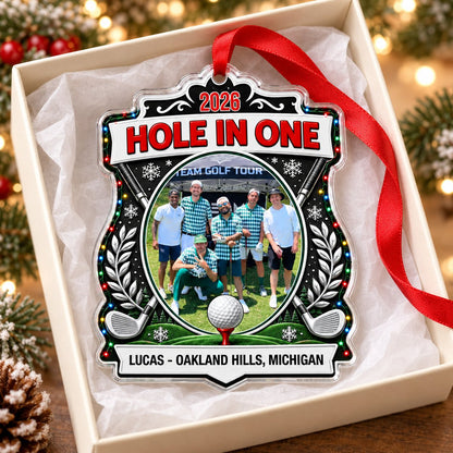 Acrylic crest ornament with golf photo, crossed clubs, Christmas lights, snowflakes, and HOLE IN ONE 2026 text.