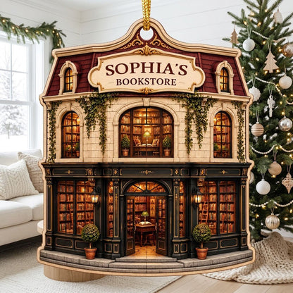 Custom-cut ornament shaped like a vintage bookstore with green and gold storefront and 'BOOKSTORE' text personalized abo