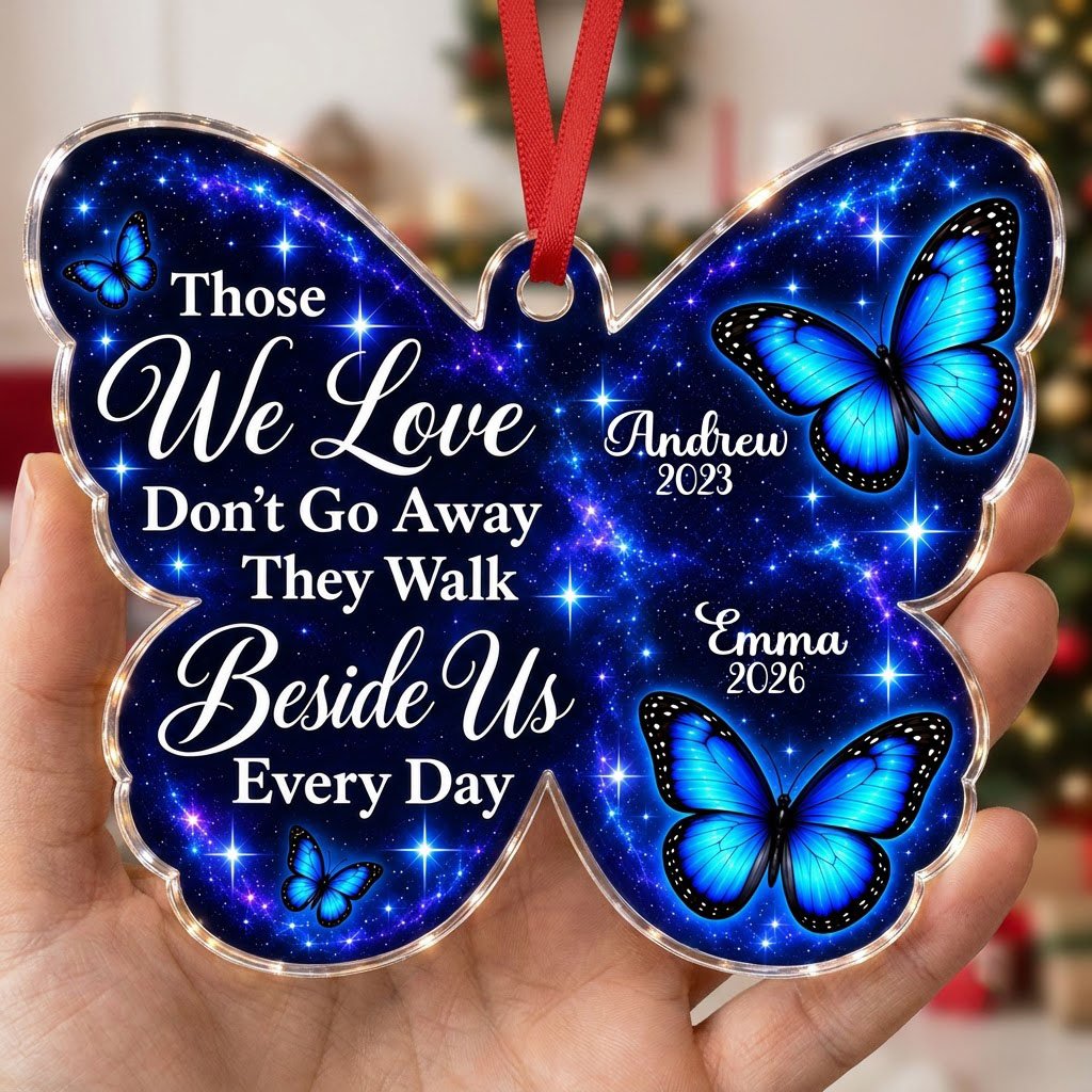 Butterfly-shaped ornament with blue butterflies and a galaxy background, reading Those We Love Don't Go Away.
