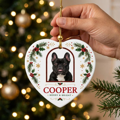 Heart ceramic ornament with dog photo in red-green plaid arch, holly, pine, gold snowflakes, and MERRY & BRIGHT text.