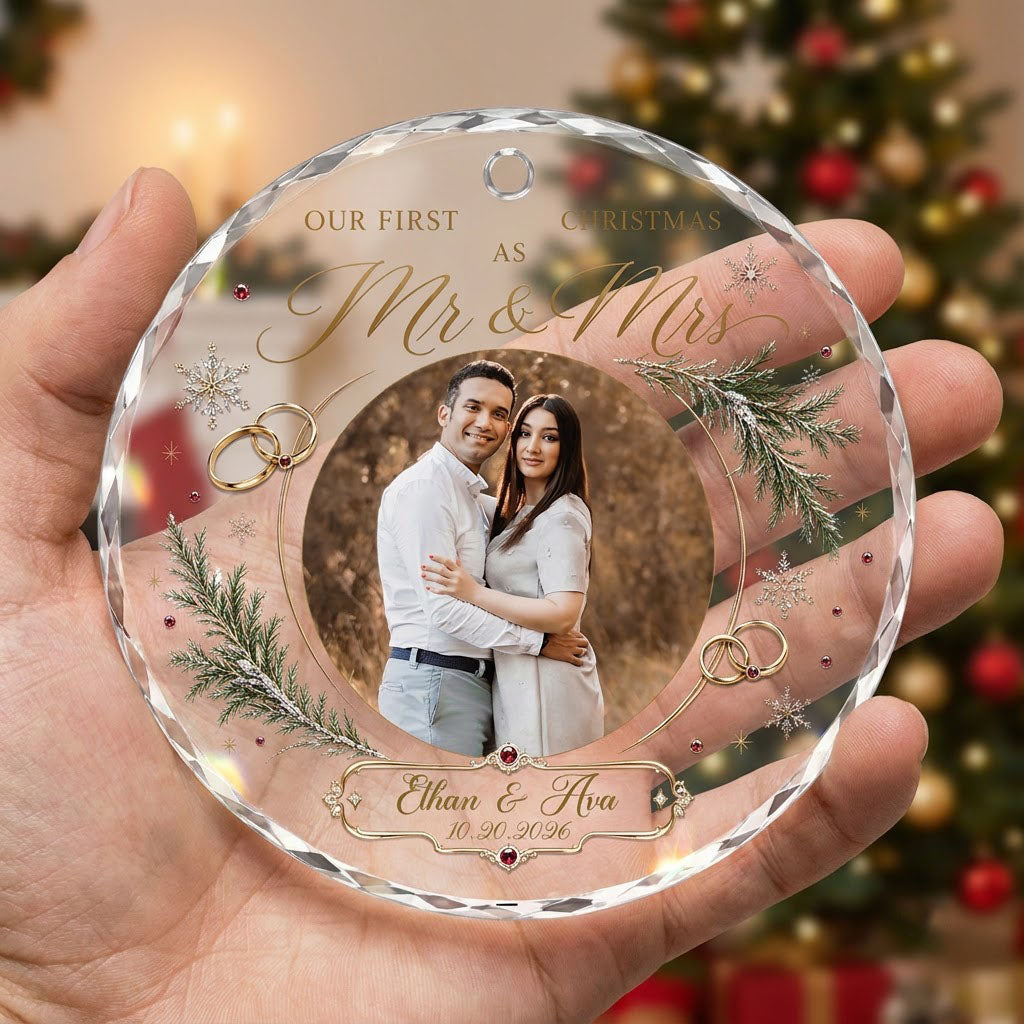 Round glass ornament with couple photo, gold wedding rings, snowflakes and 'OUR FIRST CHRISTMAS AS Mr & Mrs'.