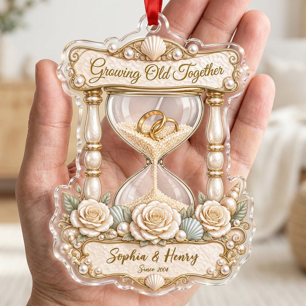 Acrylic hourglass ornament with gold rings, roses, seashells, pearls, and Growing Old Together text.