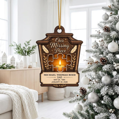 Wood ornament with lantern-style frame, puzzle-piece cutout revealing candle glow, “Our Missing Piece” text and feather 