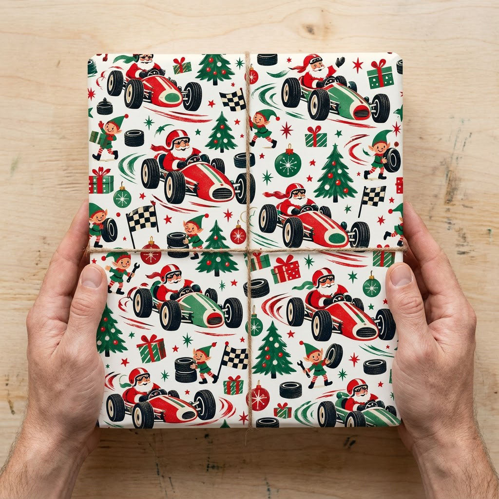 Cream wrapping paper with Santa driving vintage race cars, elves with tools and flags, trees, gifts, tires, and stars.