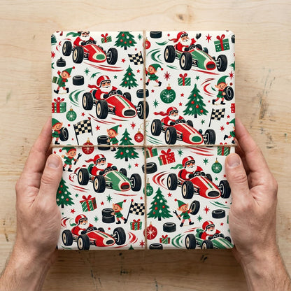 Cream wrapping paper with Santa driving vintage race cars, elves with tools and flags, trees, gifts, tires, and stars.