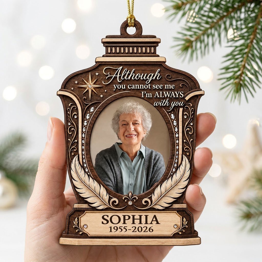 Lantern-shaped memorial wood ornament with oval photo, two feathers, starburst, fleur-de-lis and scrollwork accents.