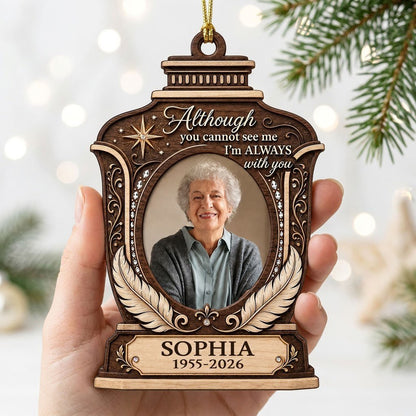 Lantern-shaped memorial wood ornament with oval photo, two feathers, starburst, fleur-de-lis and scrollwork accents.