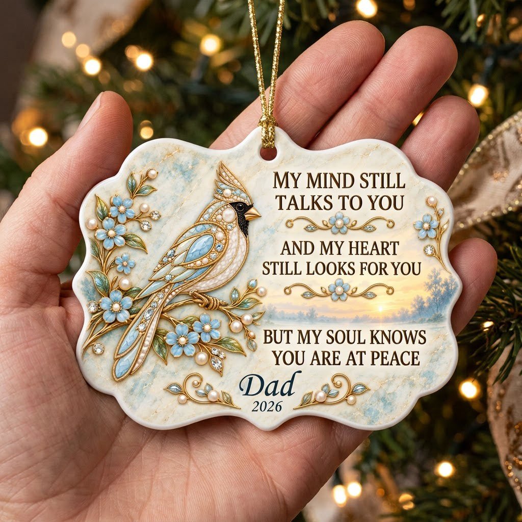 Ceramic medallion ornament with a jewel-encrusted blue bird, blue flowers, gold filigree, and a sunrise lake background.