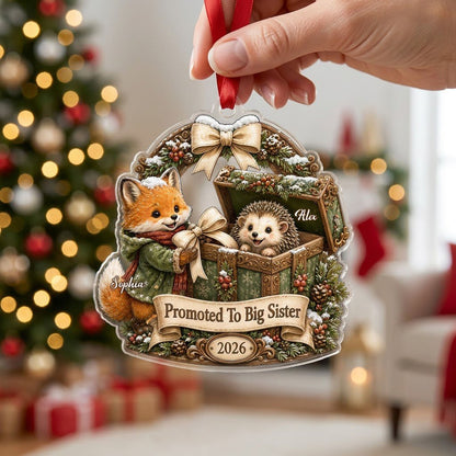 Custom-cut acrylic ornament: fox in jacket, hedgehog in box, pine arch and Promoted To Big Sister banner.