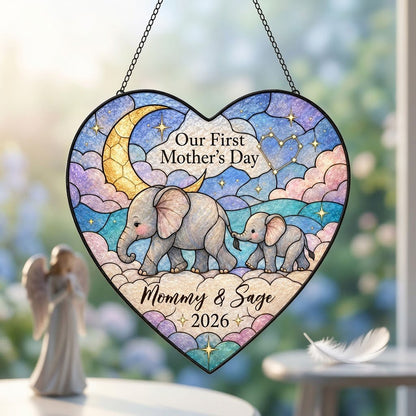 Heart stained-glass suncatcher with mom and baby elephants, crescent moon, pastel clouds, and gold stars.