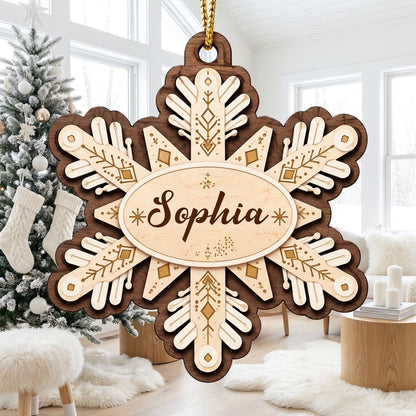 Layered wood snowflake ornament with geometric engravings and a central oval name plate for a custom name.