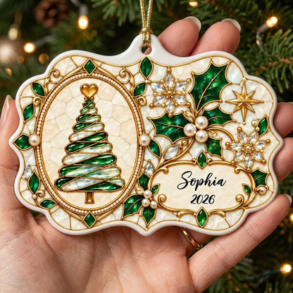 Scalloped ceramic ornament with emerald swirl tree, gold filigree, pearl accents, and a name-and-year cartouche.