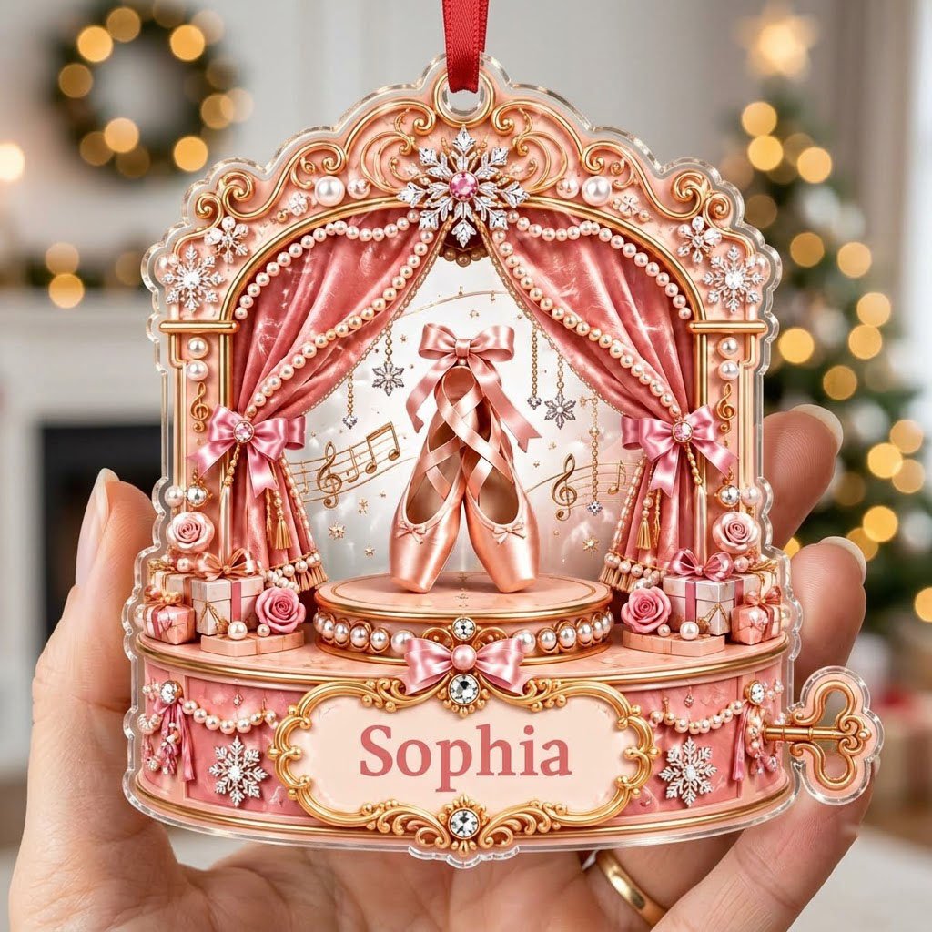 Pink ballet music box ornament with pointe shoes, velvet curtains, pearls, snowflakes, and a name plaque.