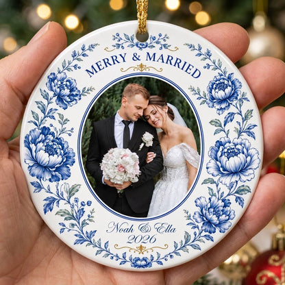 Round ceramic ornament with blue chinoiserie border, gold accents, and a circular wedding photo framed at center.