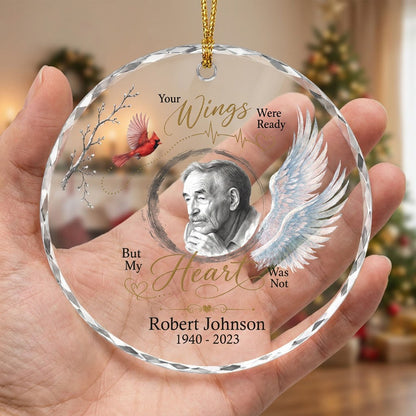 Round glass ornament with a sketch portrait frame, blue angel wing, red cardinal and 'Your Wings Were Ready' memorial te