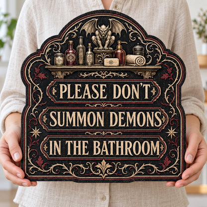 Ornate arched wooden sign with a gargoyle shelf and the message Please Don't Summon Demons in the Bathroom.