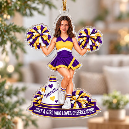 Custom-cut acrylic ornament of a cheerleader with pom-poms, megaphone, photo face, name banner and red ribbon.